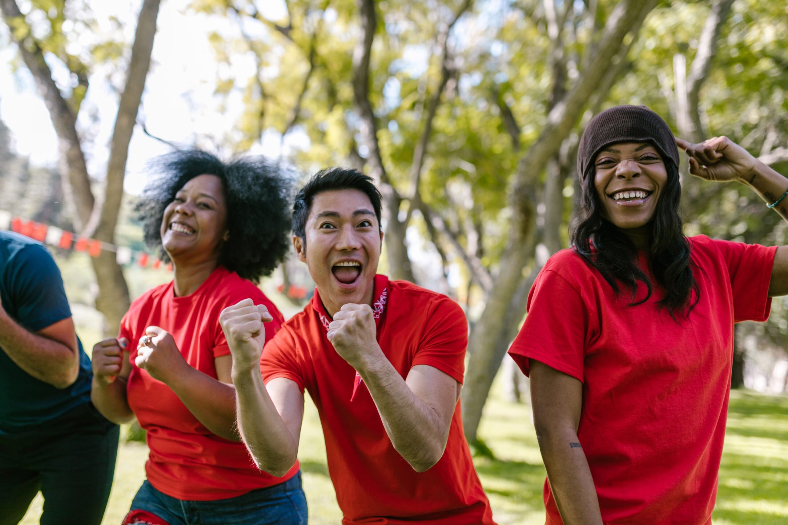 Vibrant group of diverse adults celebrating and enjoying a sunny outdoor event.